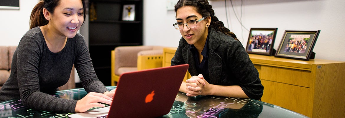 Two students working together on laptop at ASU's West campus