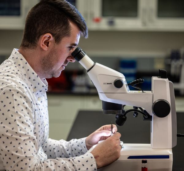 Man looking into a microscope 